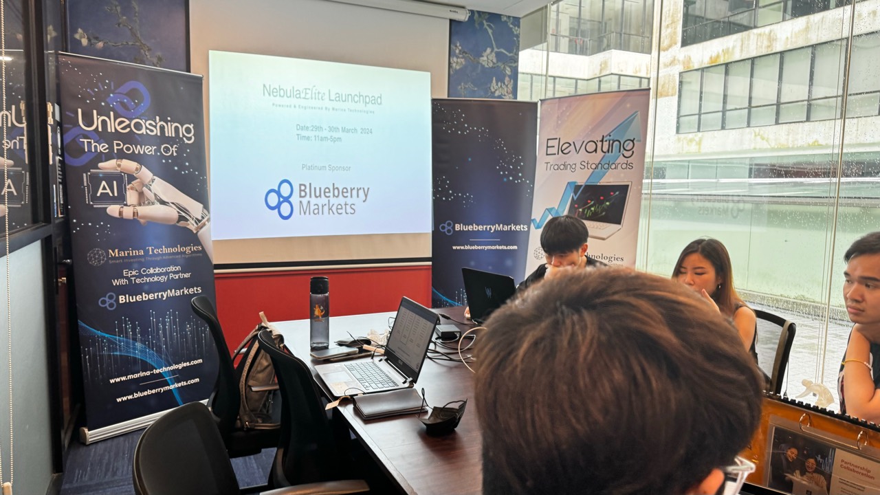 Launchpad boardroom setup with laptops and banners