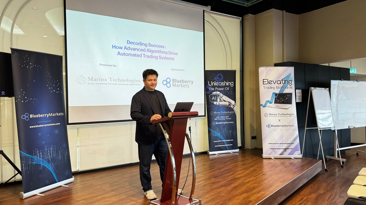 Lucas Loo standing at podium before a trading technology presentation
